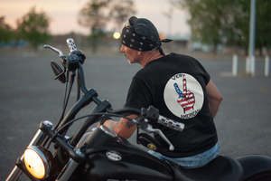 Man wearing a Very American black vintage t-shirt on a motorcycle.
