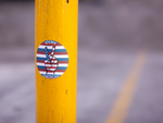 Logo sticker on a parking pole.